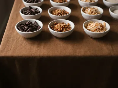 Chocolate curls, crushed praline and toasted coconut flakes in small ceramic pinch pots
